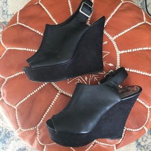 Black faux leather wedges